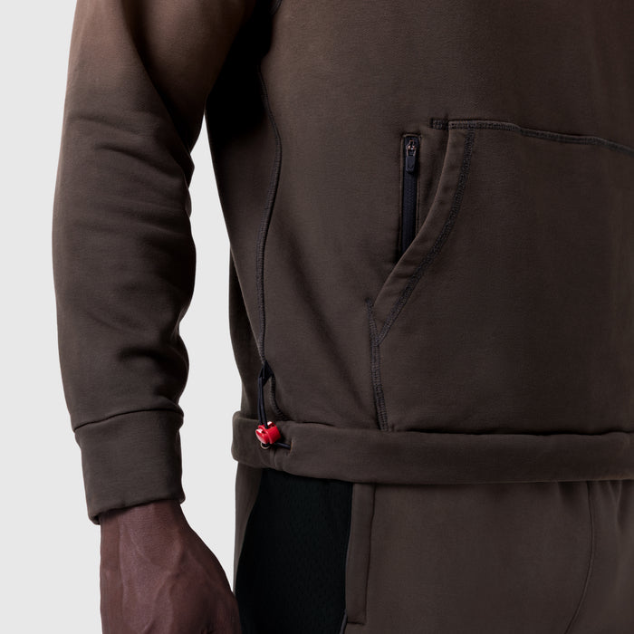 Tech-Terry Training Hoodie in dark earth, worn by model showing zipper detail and waist adjustment