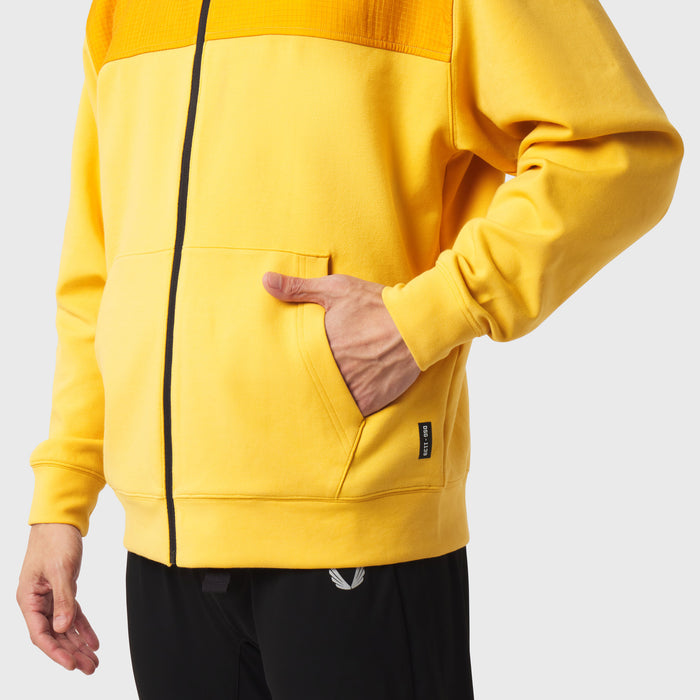Dri-Core Sidelock Full Zip hoodie in amber yellow, modeled with hand in pocket