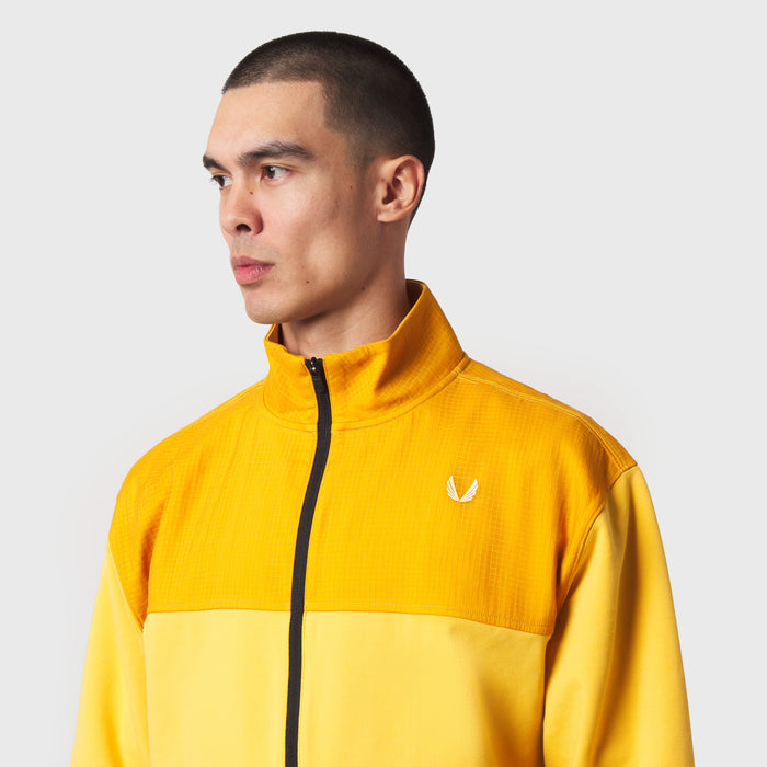 Dri-Core Sidelock Full Zip jacket in amber yellow, worn by model in profile view