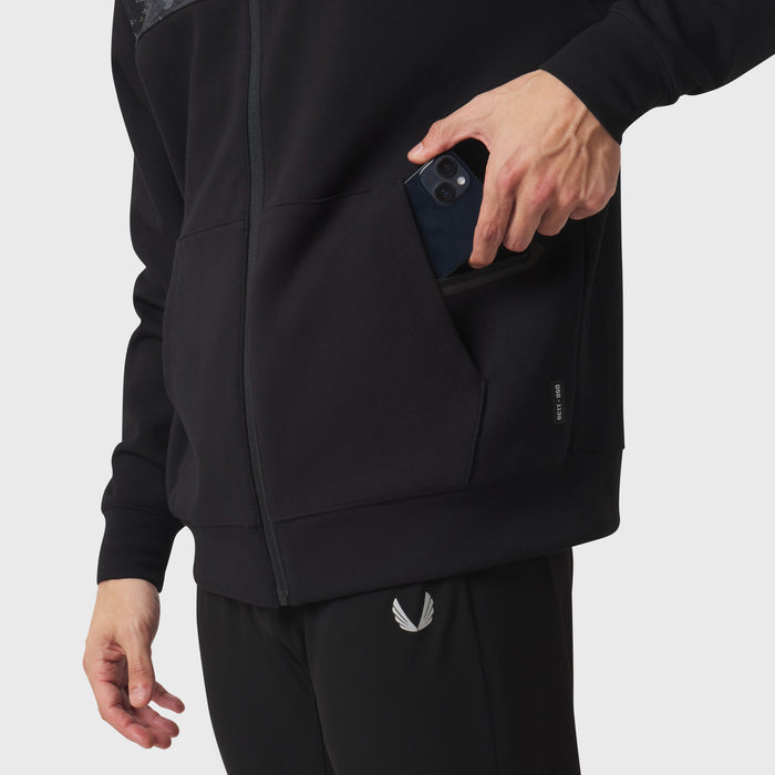 Dri-Core Sidelock Full Zip hoodie in black, worn by model holding phone in pocket