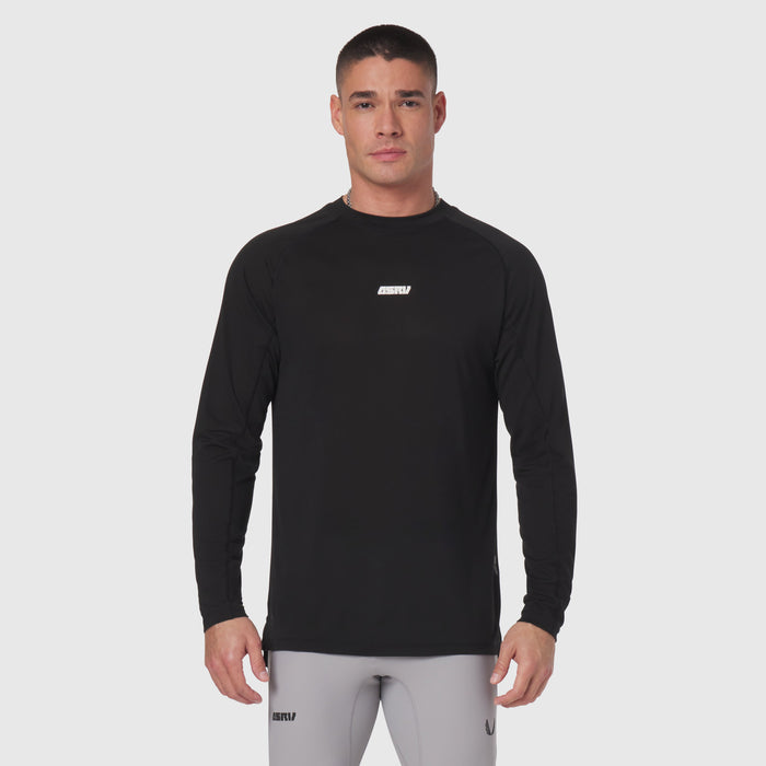 Polartec® Delta longsleeve in black, worn by model with gray joggers, front view