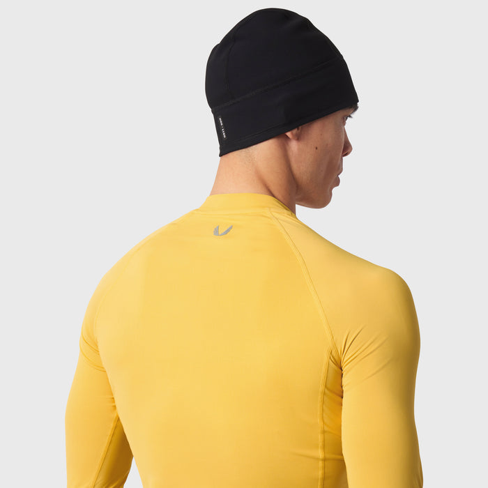 LYCRA® ADAPTIV Baselayer Longsleeve in amber yellow, worn by model, back view