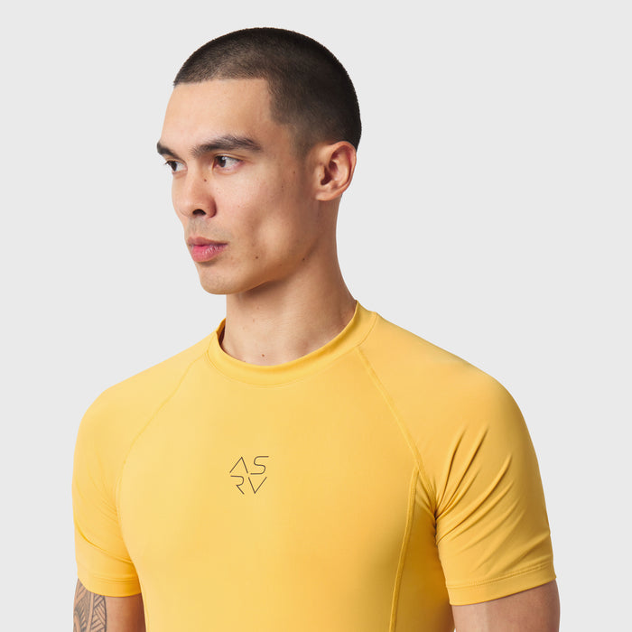LYCRA® ADAPTIV Baselayer Shortsleeve in amber yellow, worn by model in profile view