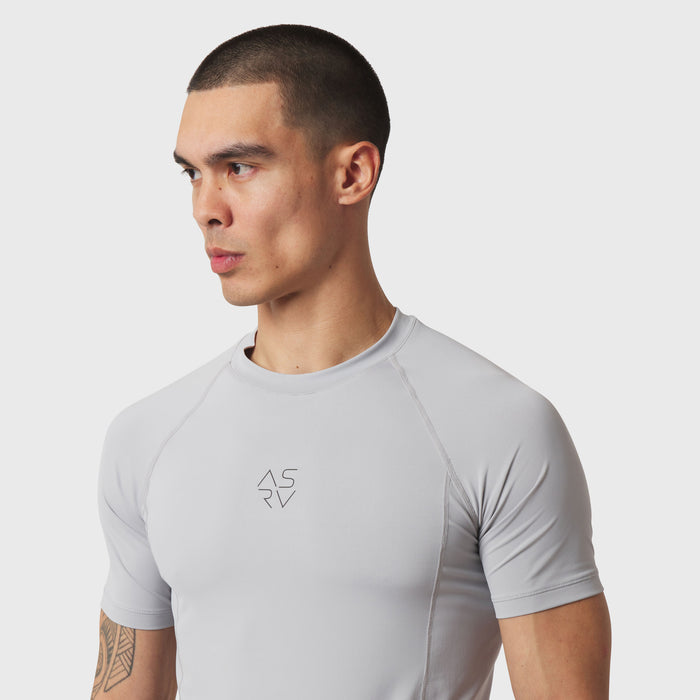 LYCRA® ADAPTIV baselayer short-sleeve tee in slate grey, worn by model, front-facing side view