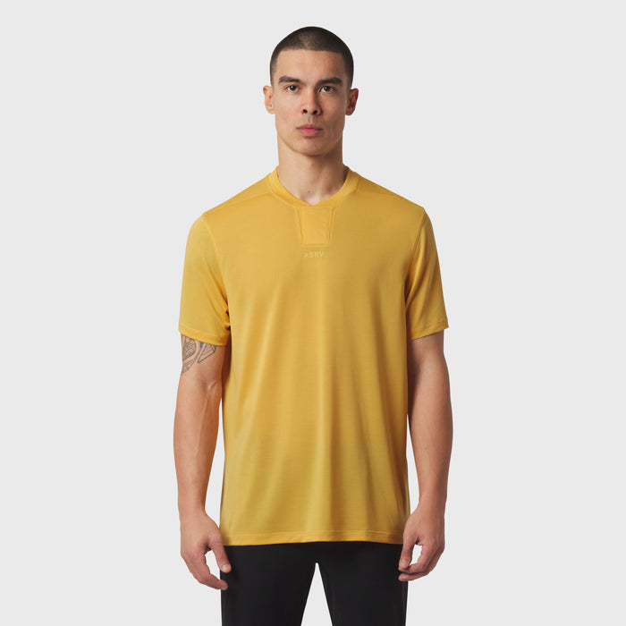 Polartec Delta Polo in amber yellow worn by male model, front view