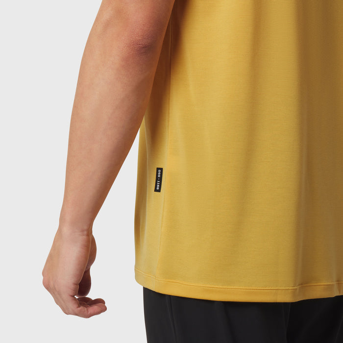Polartec® Delta Polo in amber yellow worn by model, side view showing arm and torso