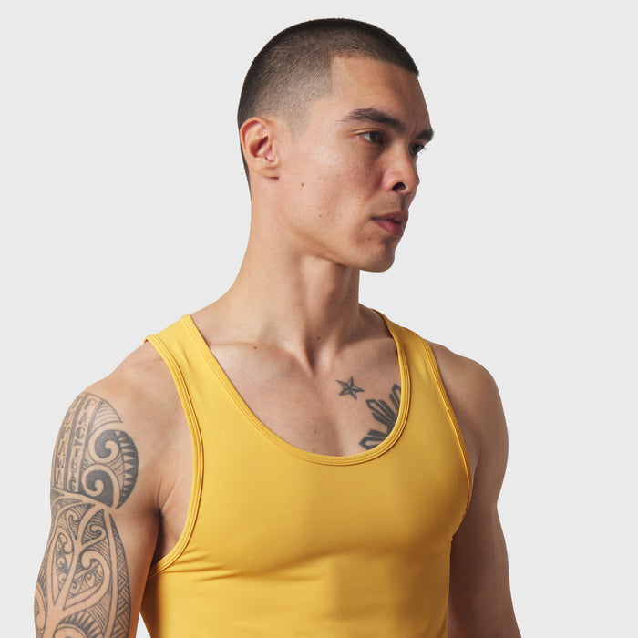 LYCRA® ADAPTIV Baselayer Tank in amber yellow, worn by model, side profile view