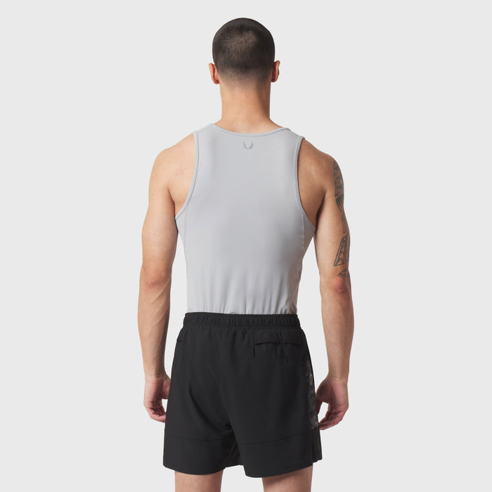 LYCRA® ADAPTIV Baselayer Tank in slate grey worn with black shorts, back view