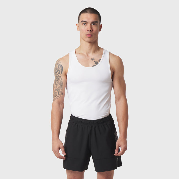 White LYCRA® ADAPTIV Baselayer Tank worn with black shorts, front view on model