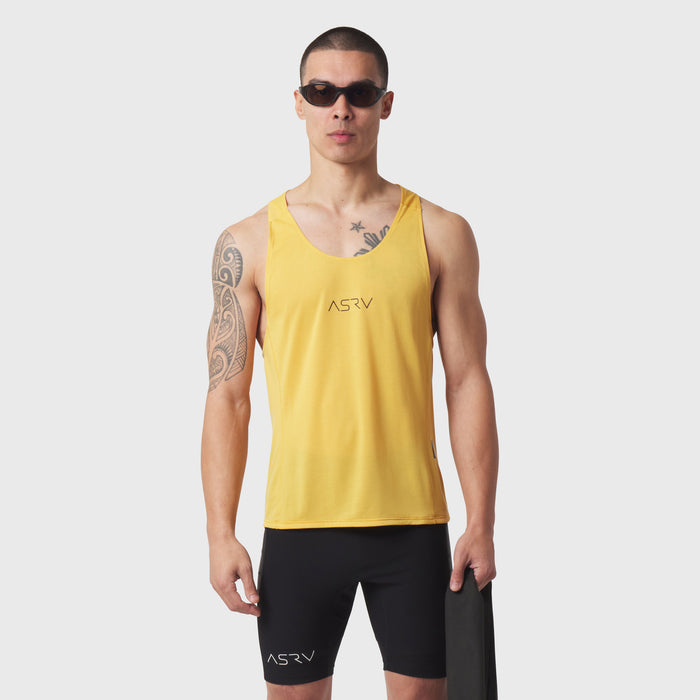 Polartec® Delta Singlet in amber yellow worn by male model with black shorts, front view