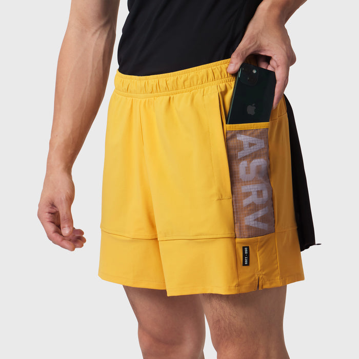 Tetra-Lite Adventure Short in amber yellow worn by model, side view showing phone pocket