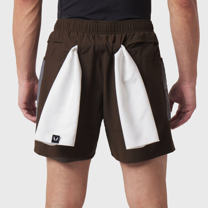 Tetra-Lite Adventure Short in dark earth worn by model, back view with white towels