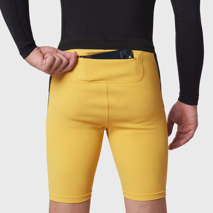 Lycra Ribbed Run Half-Tight in amber yellow worn by model, front view with hand in pocket