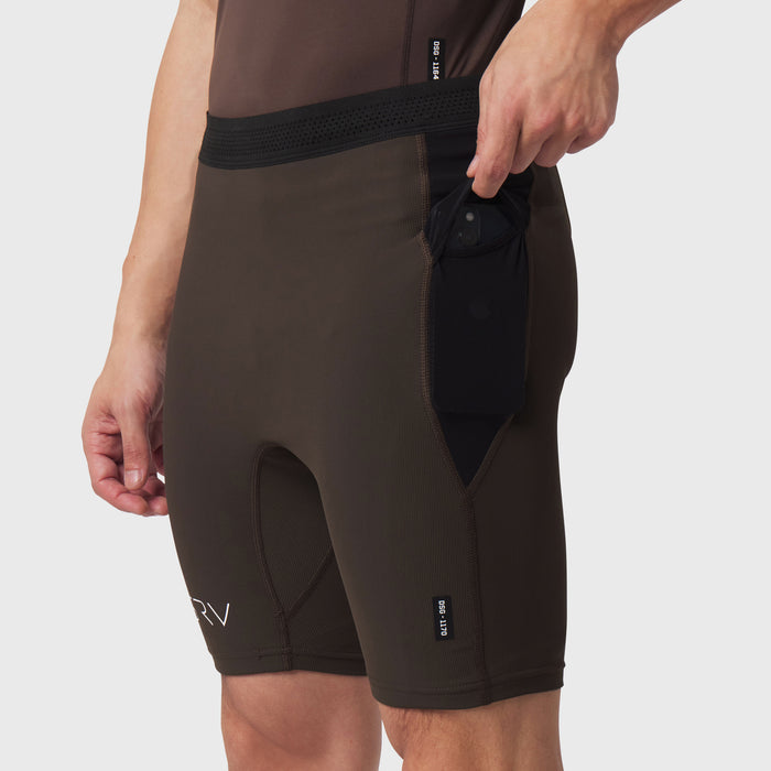Dark earth Lycra ribbed run half-tight shorts on model, side view with pocket detail