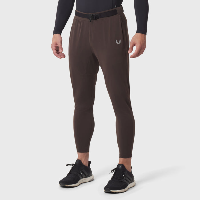 Hybrid Belt-Pack Run Jogger in dark earth worn by male model, front view