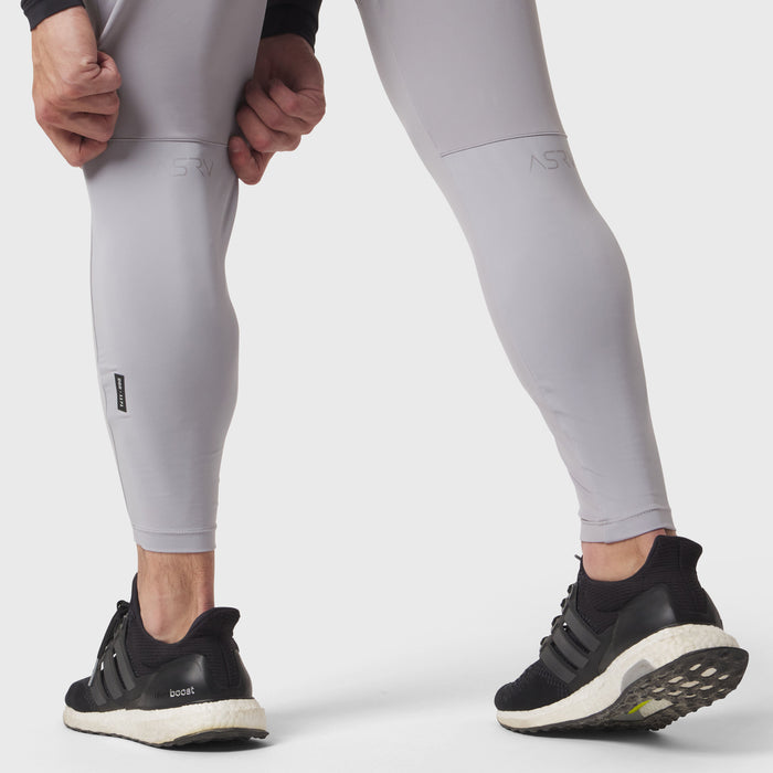 Slate grey hybrid belt-pack run jogger worn by model, calf-length view with black sneakers