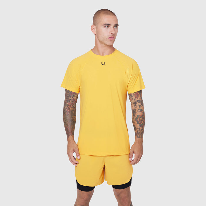 Laser-Vent™ Training Tee in amber yellow worn with matching shorts, front view on model