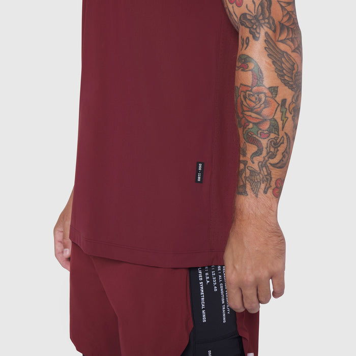 Laser-Vent Training Tee in Crimson worn by model showing side view with tattoo visible