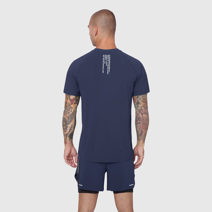 Laser-Vent Training Tee in navy, back view on model with tattoos