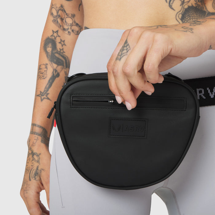 Trail Pack in black, worn as crossbody bag on model