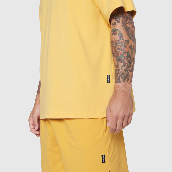 Supima Ice-Skin Reversible Tee in amber yellow worn by model, side view