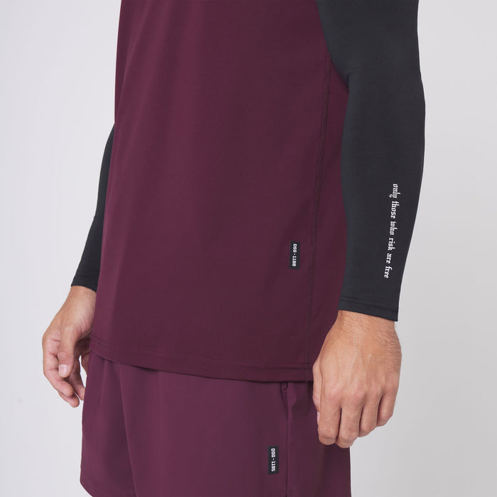 Warpflexx-Lite Training Tank in merlot worn with black long sleeve, side view