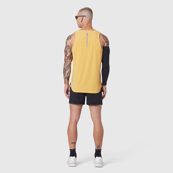 Aerotex Perforated Run Tank in amber yellow, worn by model from back, paired with black shorts