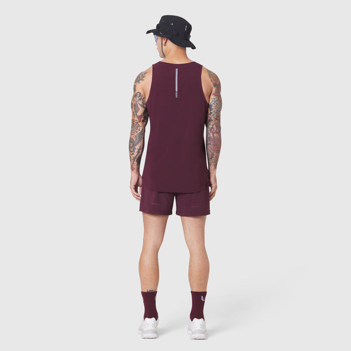 Aerotex Perforated Run Tank in merlot, back view on model with matching shorts
