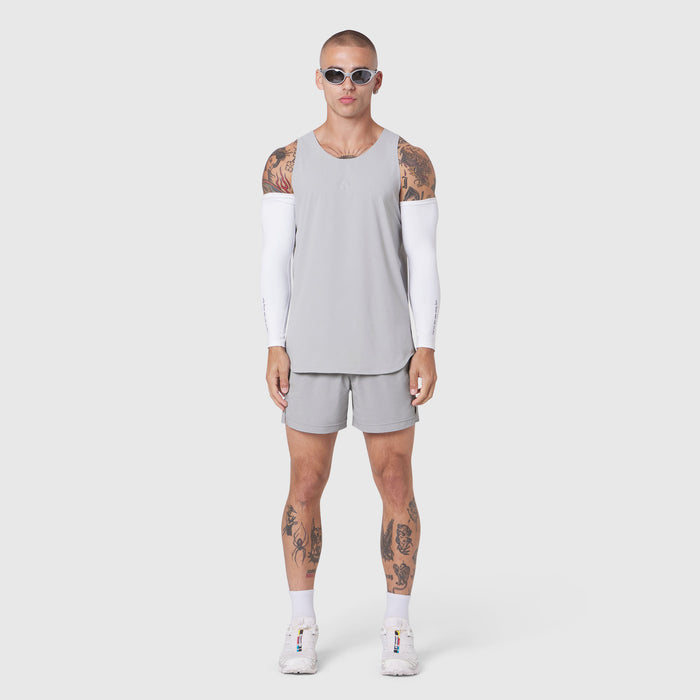 Aerotex Perforated Run Tank in slate grey, worn with matching shorts and white arm sleeves