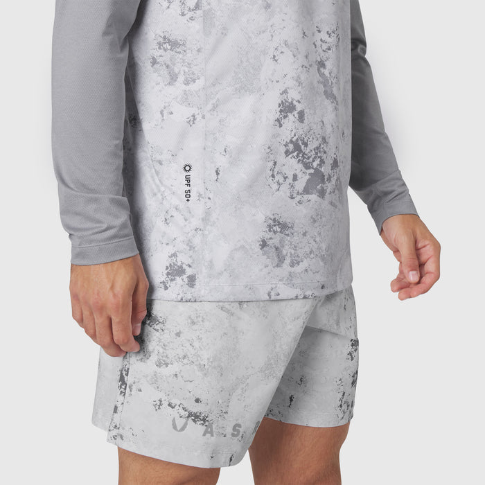 AEROSILVER® UPF50+ Run Long Sleeve in Sedona Snow Camo worn with matching shorts, side view