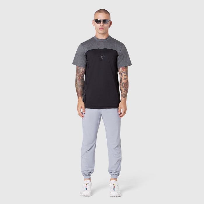 AEROSILVER® UPF50+ Run Tee in black and grey colorblock, worn by model with light grey joggers