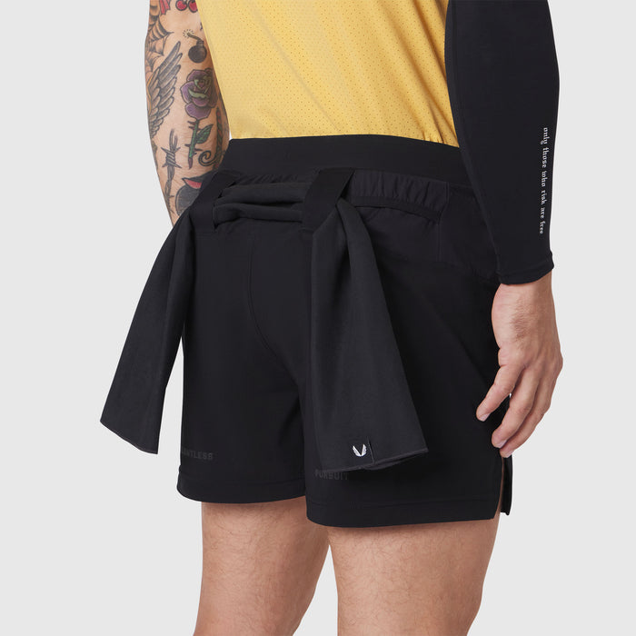Aerotex Distance Run Short in black worn by model, side view with shirt tied at waist