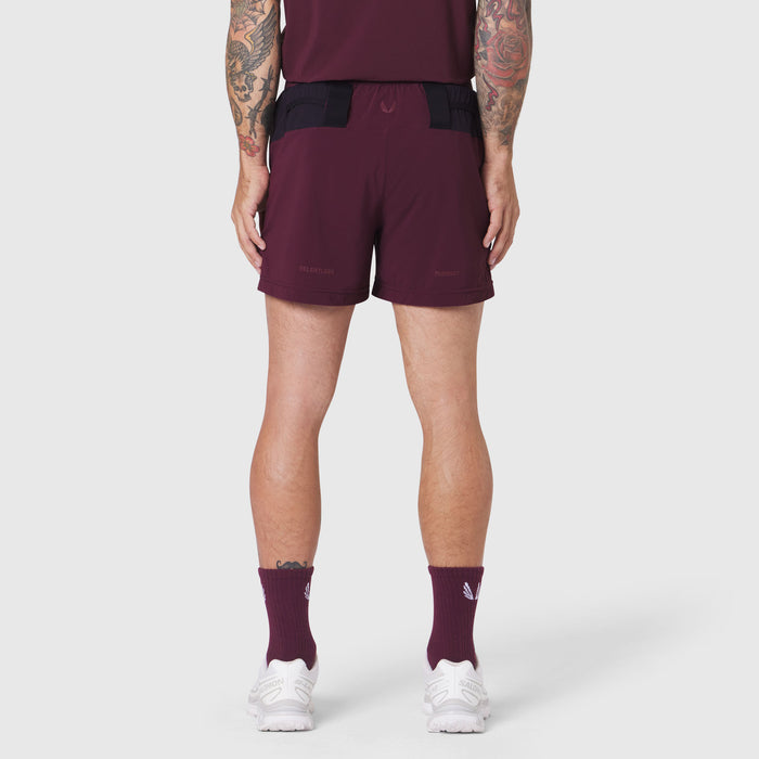 Aerotex Distance Run Short in merlot, rear view on model wearing matching tank and socks