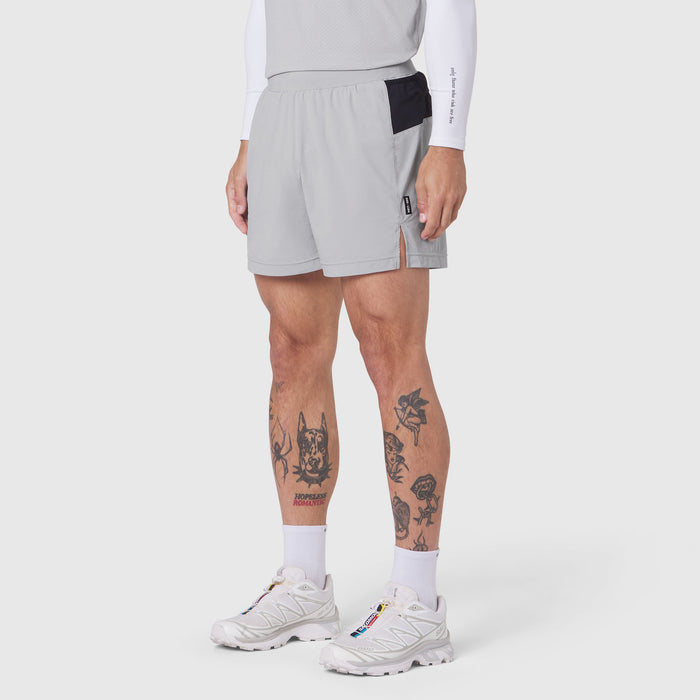 Aerotex™ Distance Run Short in slate grey, modeled on male runner with white long sleeve shirt and white sneakers