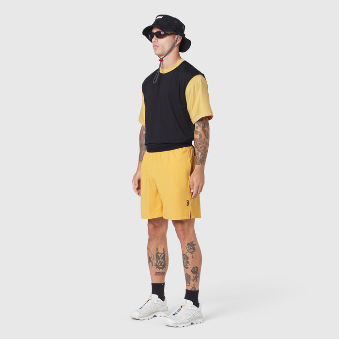 TETRA-LITE® 7" Linerless Training Short in Amber, modeled with black and yellow colorblock tee