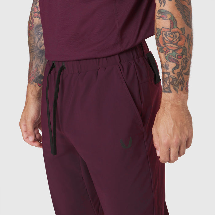 TETRA-LITE Training Jogger in merlot worn by model, side view detail of pocket and drawstring