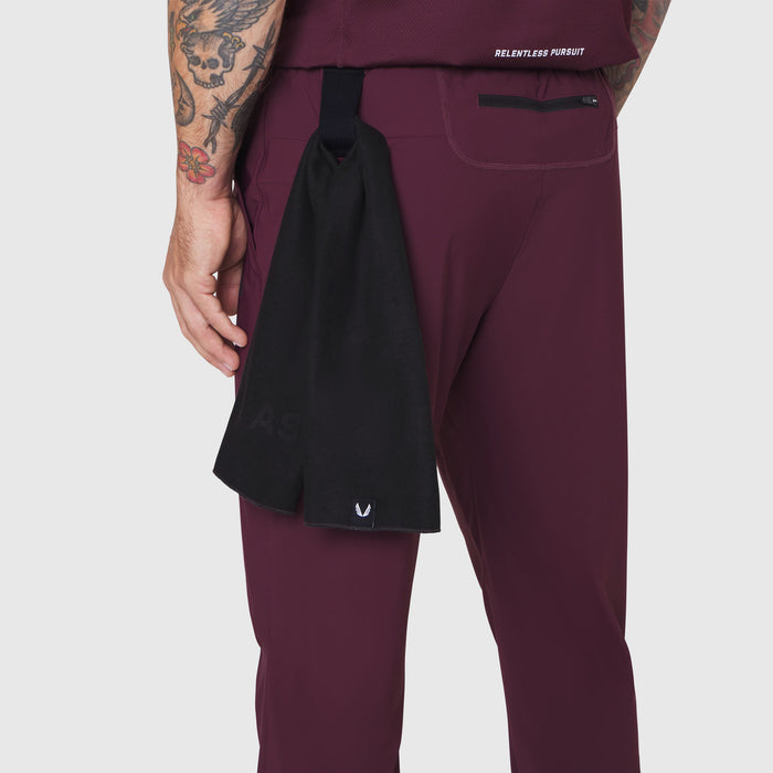 TETRA-LITE Training Jogger in merlot worn by model, side view with black towel