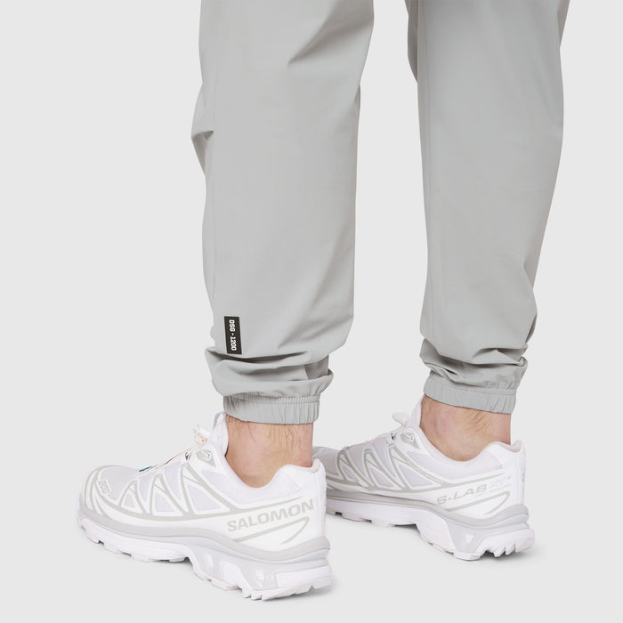 Slate grey Tetra-Lite training jogger worn with white sneakers, calf detail view