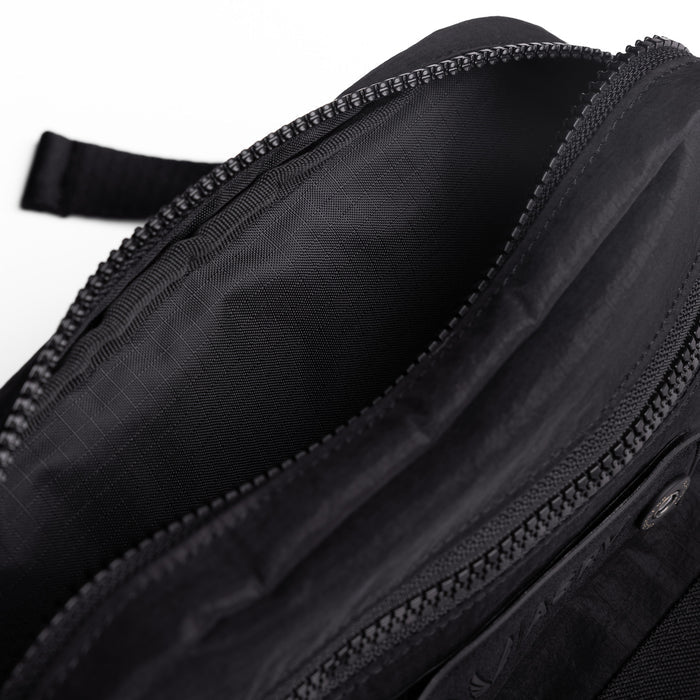 Flatlay 1231 Ripstop Crossbody Bag in black, open interior detail view
