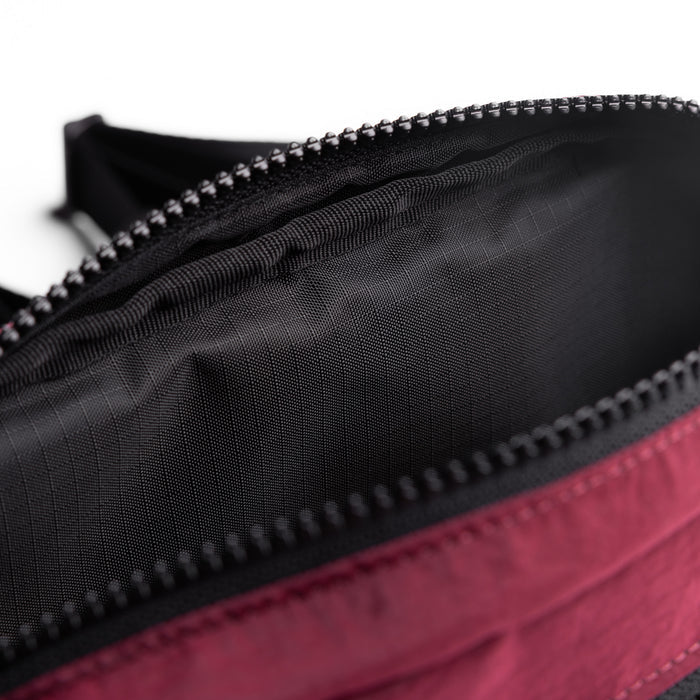Flatlay 1231 Ripstop Crossbody Bag in Crimson, detail closeup of zipper