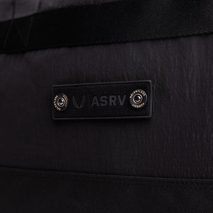 Flatlay 1234 Ripstop Duffle Bag in black, detail view of ASRV logo label