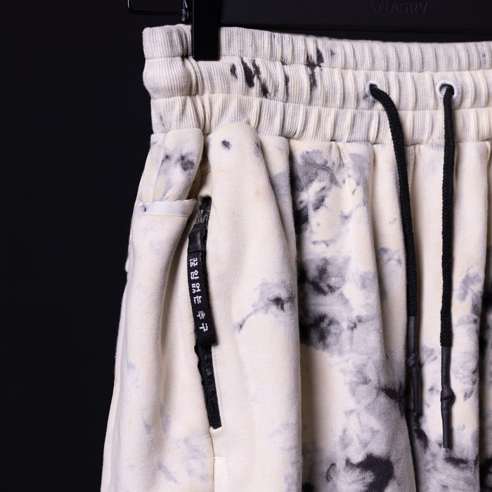 Tie dye sweat shorts in cream and gray, detail shot of drawstring and waistband