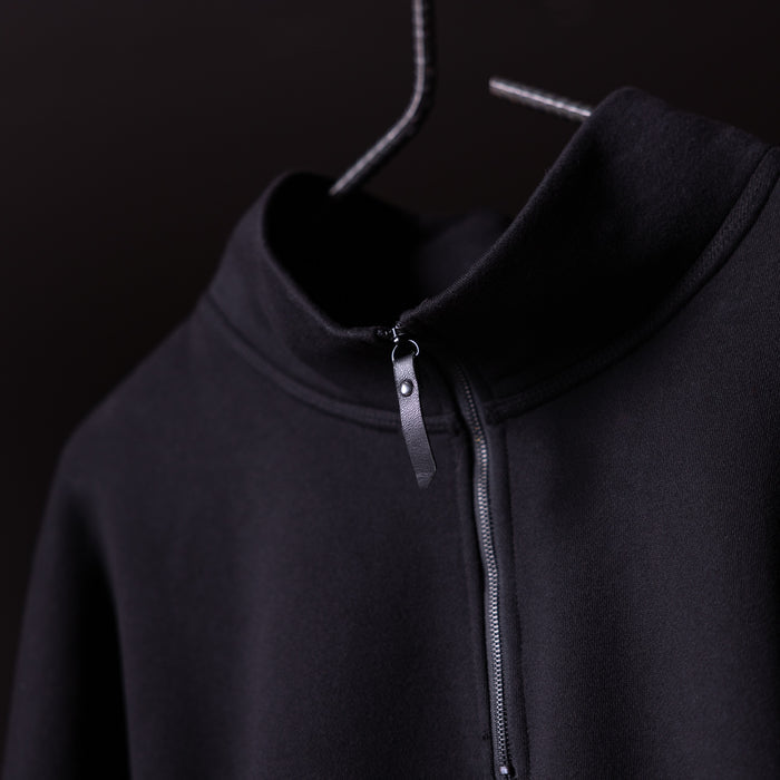 Black quarter zip hoodie on hanger, showing front neckline and zipper detail