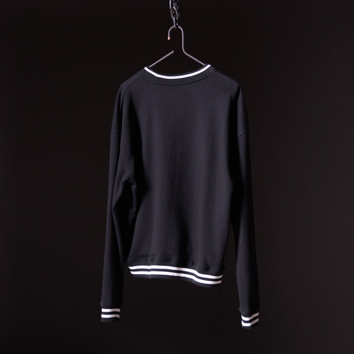 Black crew neck sweatshirt with white stripe trim, displayed on hanger against dark background