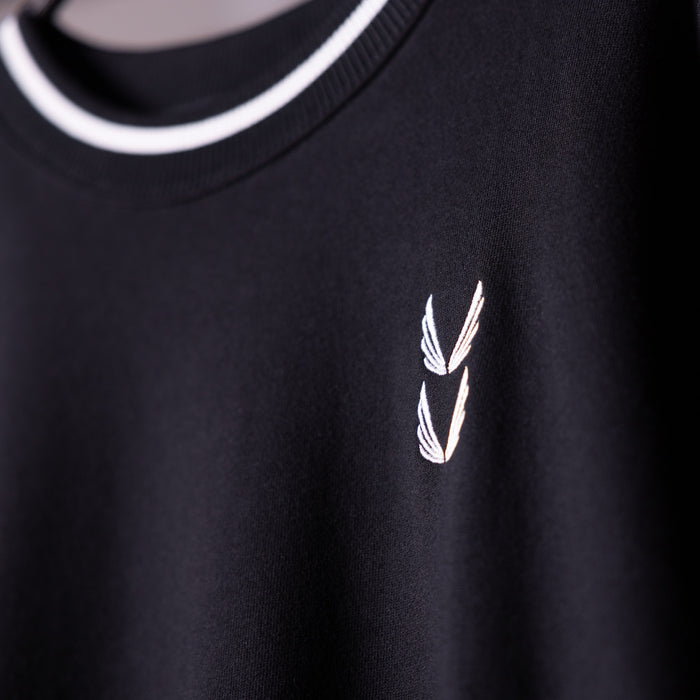 Black crew neck sweatshirt with white winged logo detail, worn on model