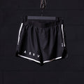 flatlay ASRV Reflective 3" Run Short in black with white trim, front view on hanger