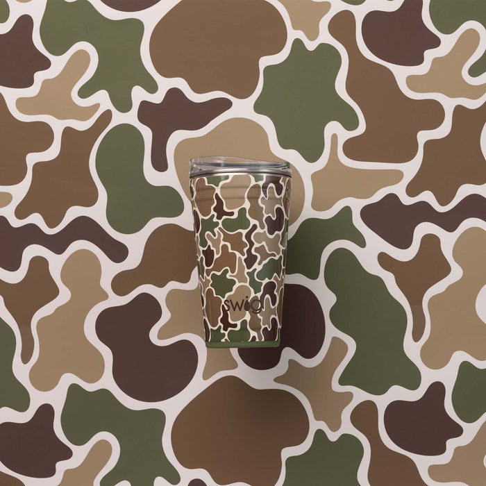 Swig Life 22oz travel mug in Hunting Camo pattern placed against matching green, brown, and tan camo background.