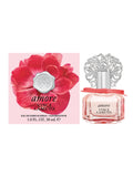 A bottle of Vince Camuto Amore 1.0 oz Eau de Parfum Spray with a decorative silver cap is displayed beside its pink box, which showcases a bold red flower and detailed product information. This captivating fragrance from Vince Camuto combines sparkling fruits with sensual sandalwood, perfectly embodying the essence of Amore in every spray.