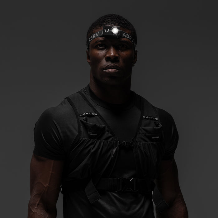 Black ASRV x Bookman Monocle tactical vest worn by male model with headlamp