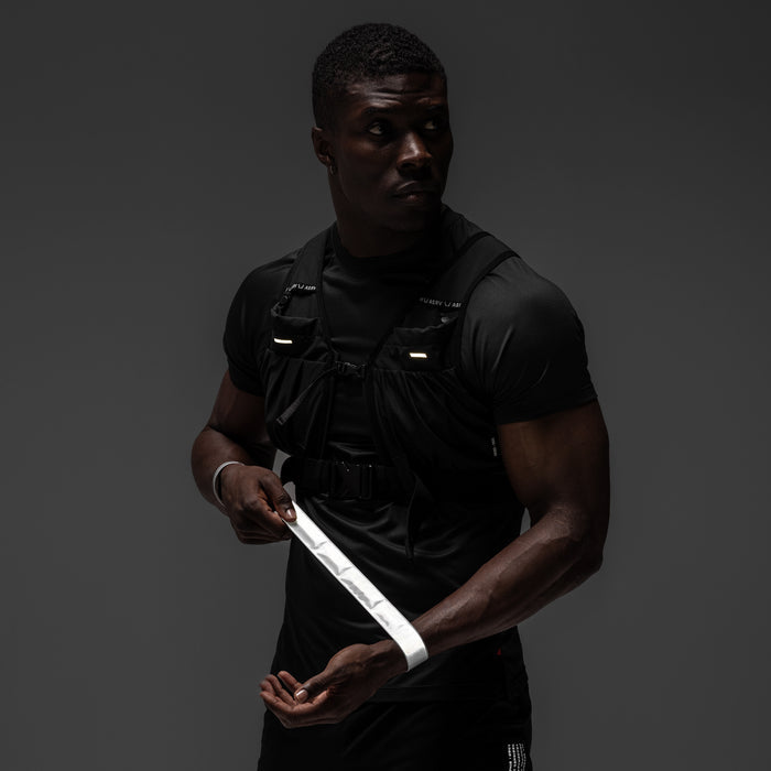 ASRV x Bookman Reflective Snap Band in white, worn and held by model
